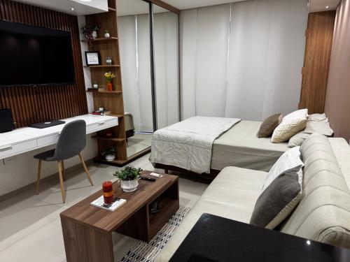 a hotel room with a bed and a desk and a couch at Sirari Palm 102 in Santa Cruz de la Sierra
