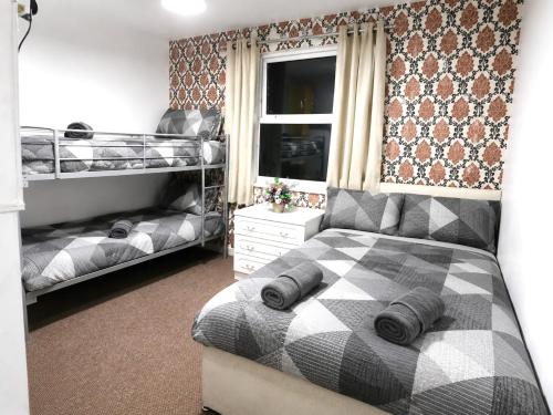 a bedroom with two bunk beds and a window at Blackpool Central Lodge in Blackpool