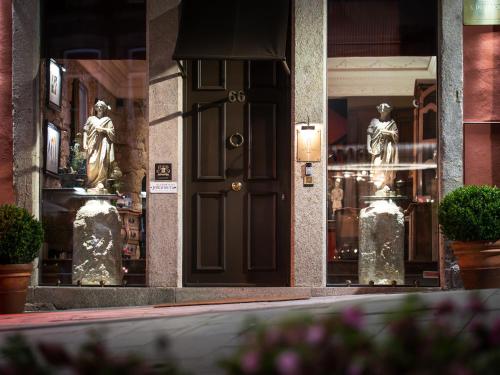 a front door of a store with statues of women at M Maison Particulière Porto in Porto