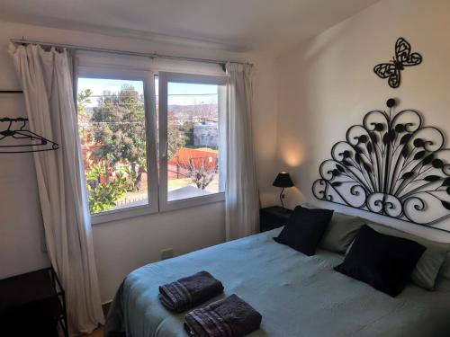 a bedroom with a bed and a large window at LA CASA Nostra in Valle Hermoso