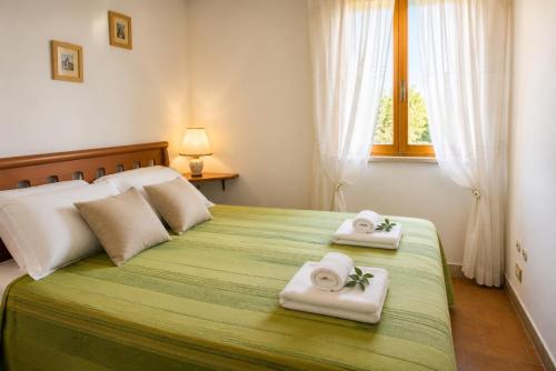 a bedroom with a large bed with towels on it at Villa Olimpo B&B in Fasano