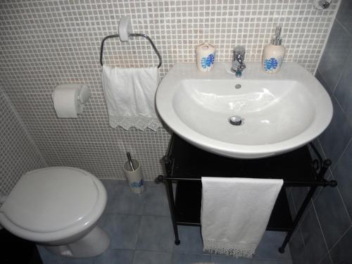 a bathroom with a white sink and a toilet at Apartment Milano in Matulji