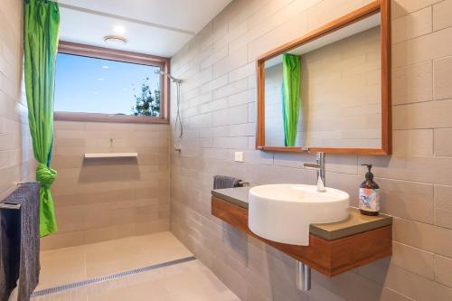 a bathroom with a sink and a mirror at East Lane in Tathra