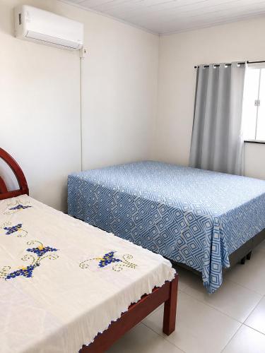 a bedroom with two beds and a window at Refúgio em Jacumã Conforto, Tranquilidade e Praia in Conde