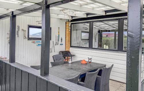 a patio with a table and chairs on a porch at Awesome Home In Thyborøn With Wifi in Thyborøn