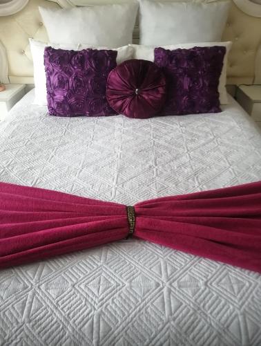 a red umbrella laying on top of a bed at Iris Bnb on Vaal in Vanderbijlpark