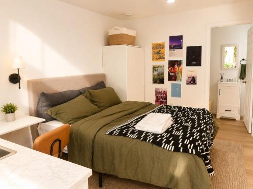 a small bedroom with a bed and a table at Tiny Studio in Orange Garden in Los Angeles