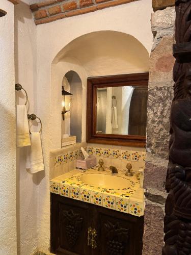 a bathroom with a sink and a mirror at Tres Fuentes Hotel Boutique in San Miguel de Allende