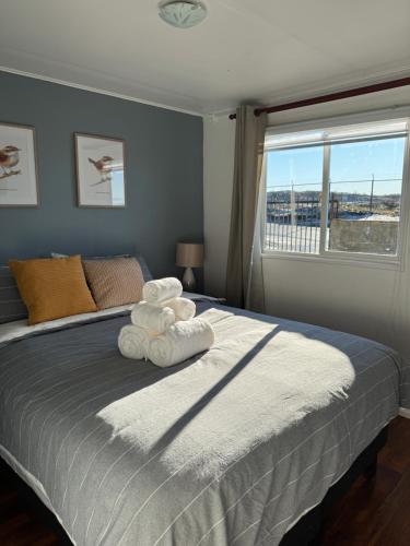 a bedroom with a bed with towels on it at Casa 2 dormitorios - Punta Arenas - Río Seco in Punta Arenas