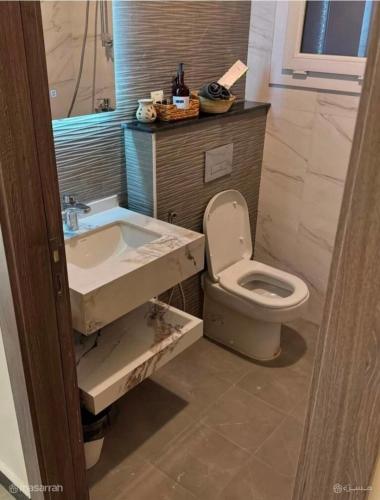 a bathroom with a sink and a toilet at AlSeef 161 in Al Sharqiyah