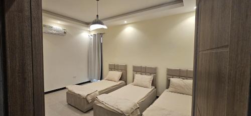 a room with two beds and a window at AlSeef 161 in Al Sharqiyah
