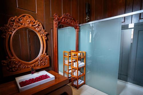 a bathroom with a sink and a mirror and a ladder at Heritage Village Resort in Kampot