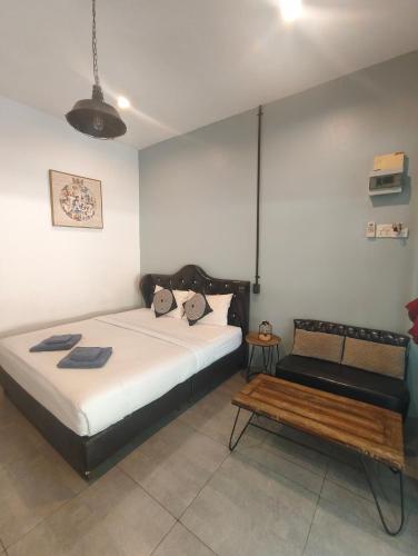 a bedroom with a bed and a bench in it at Baan Minnie in Ko Samed