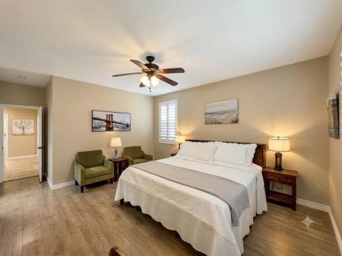 a bedroom with a bed and a ceiling fan at Amazing Grace Vacation Home in Las Vegas