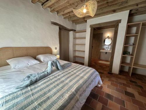 a bedroom with a large bed in a room at Le résinier in Commensacq