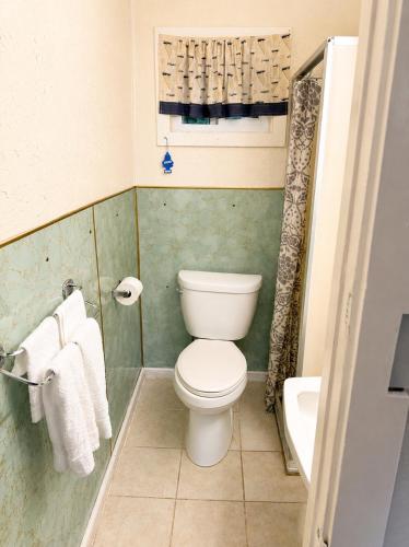 a small bathroom with a toilet and a sink at Beachway Motel in Salisbury