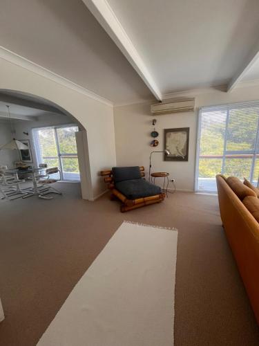 a living room with a couch and a chair at Cliff Place in Tathra