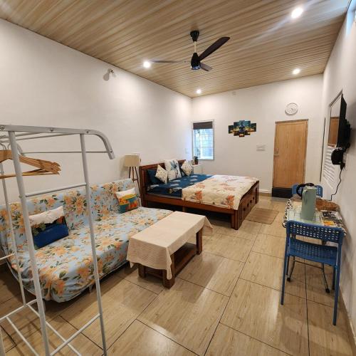 a room with two beds and a bunk bed at Sattva Farmstay in Bangalore