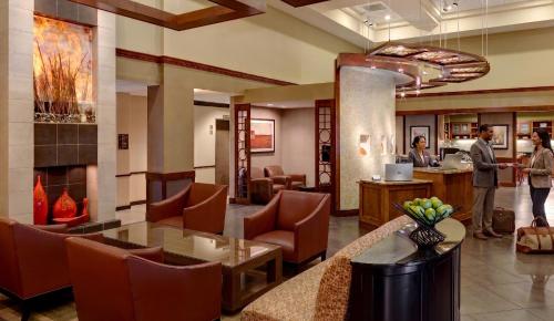a lobby of a hotel with people standing in the lobby at BNA Suites in Nashville