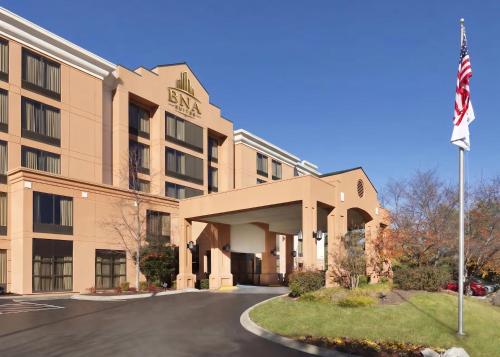 an exterior view of a hotel with an american flag at BNA Suites in Nashville