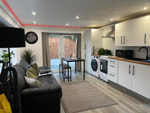 a living room with a couch and a kitchen at The Annex EV 10 per night in Southport