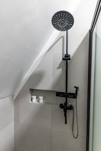 a shower in a bathroom with a shower head at Paragos Silvina's Cabin 2 Resort Hotel in Maitim