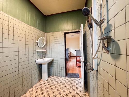 a bathroom with a sink and a mirror at Honey Home Pai in Pai