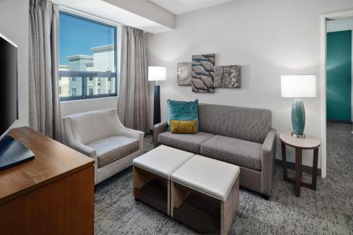 a living room with a couch and a chair at Staybridge Suites Irvine - John Wayne Airport by IHG in Irvine