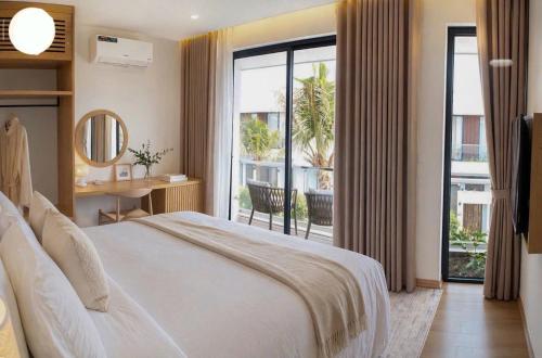 a bedroom with a large bed and a large window at Vip villa in Phú Quốc