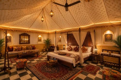 a bedroom with a canopy bed and a couch at Sunrise Resort Jaislamer in Jaisalmer