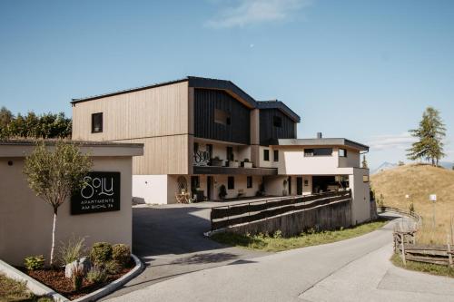 a building with a sign on the side of a road at SOLU Apartments in Seefeld in Tirol