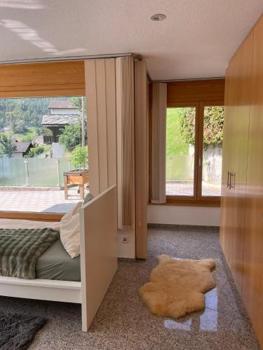 a bedroom with a bed and a large window at Château Schnidrig in Stalden