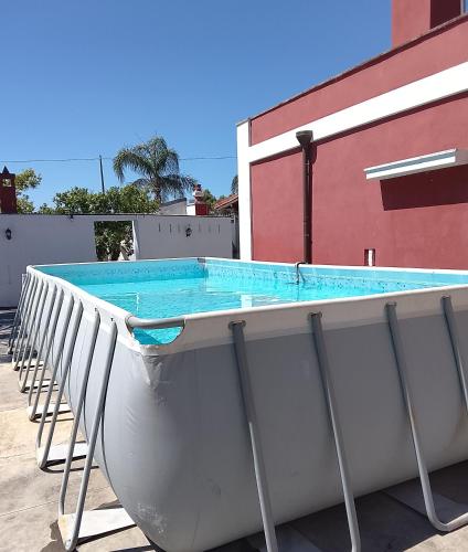 a swimming pool with a slide in front of a building at Villa rinalda Francavilla in Francavilla Fontana