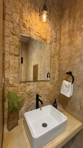 a bathroom with a white sink and a mirror at Petra By Ariché in Valladolid