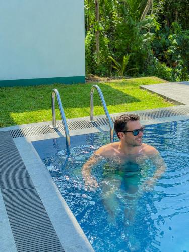 a man is in a swimming pool at Nilwadula Hotel Udawalawe in Ratkarawwa