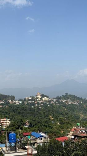 a view of a city with houses on a hill at Satikhel StayInn in Pharping