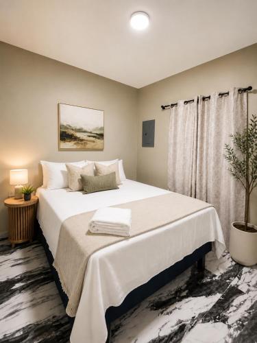 a bedroom with a large white bed and a potted plant at hotel harmony in El Edén