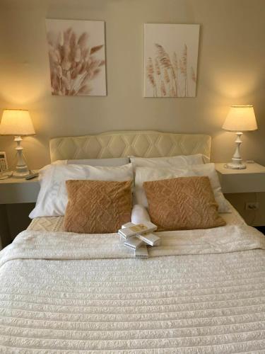 a bedroom with a large bed with two lamps at Yahay-living & Condotel in Suba