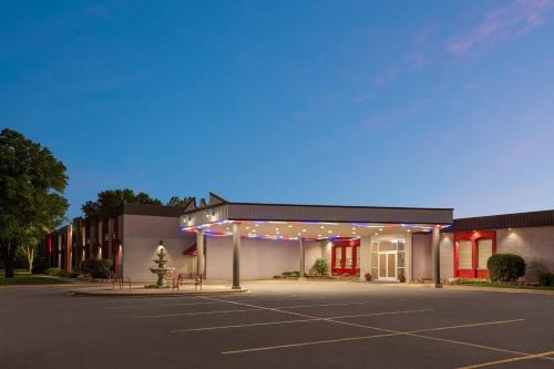 an empty parking lot in front of a building at Ramada by Wyndham Grand Forks in Grand Forks