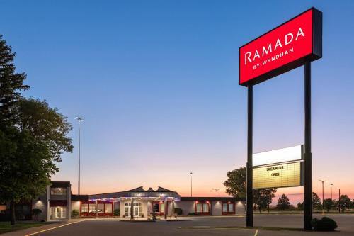 a pharmacy sign in front of a gas station at Ramada by Wyndham Grand Forks in Grand Forks