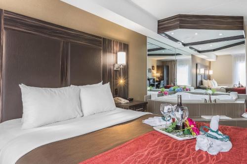a bedroom with a bed with a tray of wine glasses at Comfort Inn Trenton in Trenton