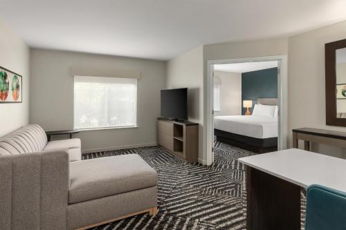a hotel room with a couch and a bed at Hyatt House Morristown in Morristown