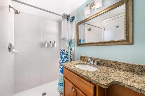 a bathroom with a sink and a shower at Coconut Palms Beach Resort II, an Ascend Collection Hotel in New Smyrna Beach