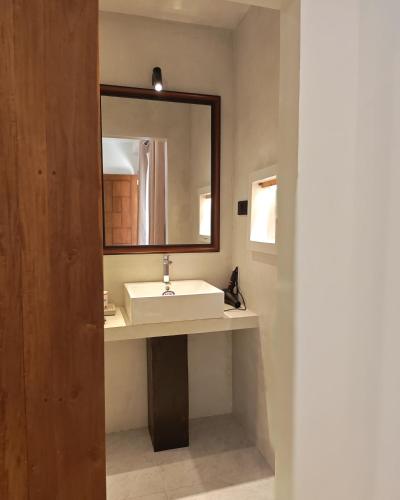 a bathroom with a sink and a mirror at Mogra Bliss in Matara