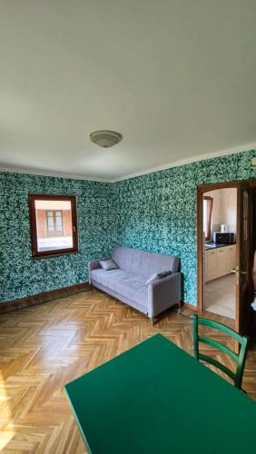 a living room with a couch and a table at La Tana del Ghiro in Condove