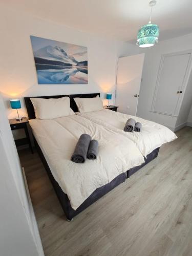 a bedroom with a large bed with two pillows on it at Pet-Friendly Home with Secure Garden nr Beamish in Birtley