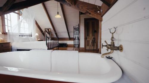 a bathroom with a white sink in a room at Hank's Folly in Wapengo