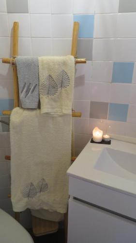 a bathroom with towels on a towel rack next to a sink at Penacova Moinho do Ligeiro near Coimbra in Penacova