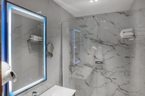 a bathroom with a shower and a sink at Jizzax Hotel Tashkent in Tashkent