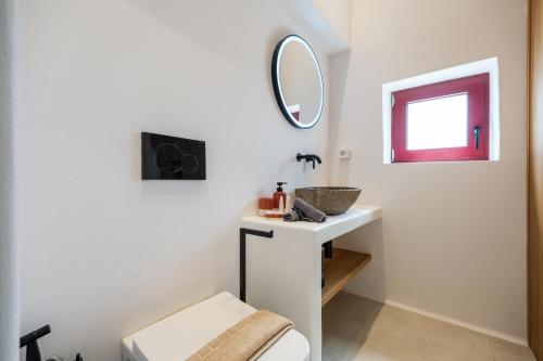 a bathroom with a sink and a mirror at Antiparos Gems - The villa in Antiparos